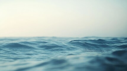 A blurred image of the ocean with soft waves and a distant horizon, creating a peaceful and calming background.