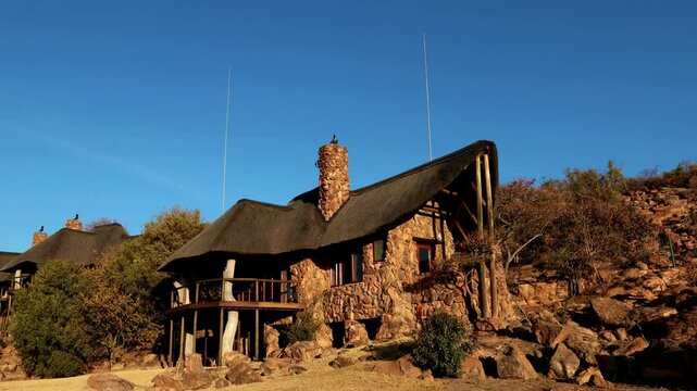 Timelapse at sunset of a safari lodge chalet - as the African sun sets brining golden colours
