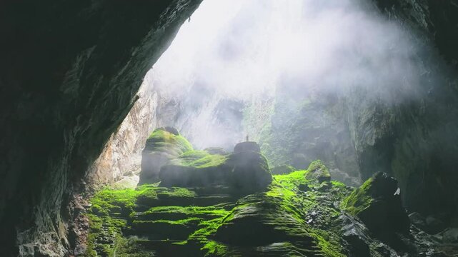 Drone footage flying backward shot tiny people in Hang Son Doong, Vietnam