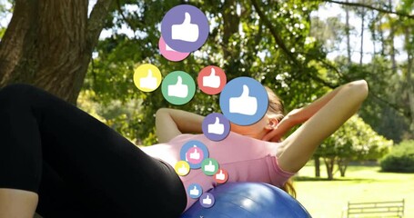 Exercising on fitness ball, woman surrounded by social media likes animation - Powered by Adobe
