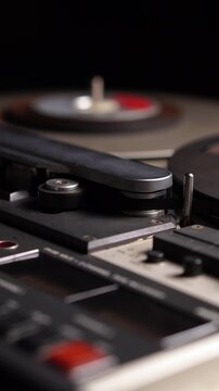 Vertical View, Professional Reel to Reel Audio Recorder and Spinning Tape, Close Up