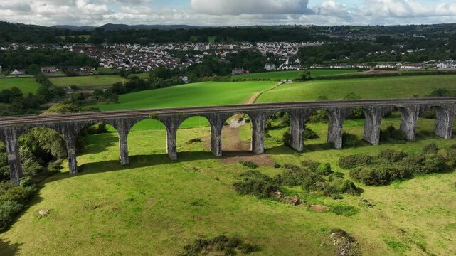 Craigmore Viaduct, County Armagh, Northern Ireland, September 2022. Drone tracks left along the old Railway Bridge with Newry town in the background on a Autumn day with sunny spells.