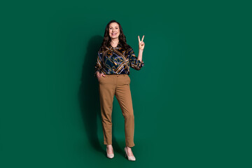 Photo of charming classy retired lady wear trendy clothes v-sign isolated on dark green color background