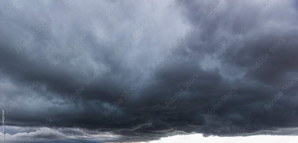 Poster the dark sky with heavy clouds converging and a violent storm before the rain.bad or moody weather s