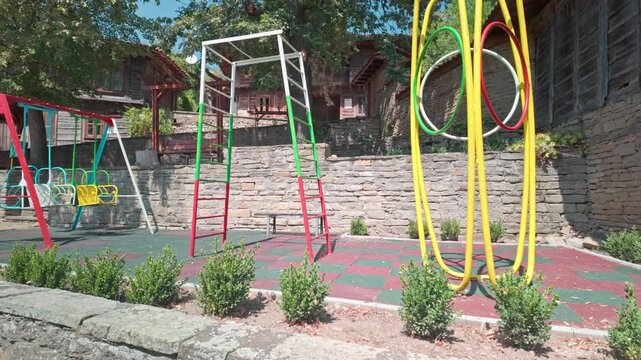 Brightly coloured children's playground, Balkan village, Zheravana.