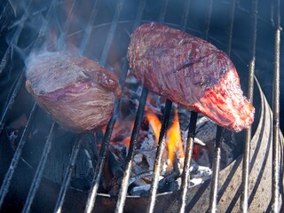 Picanha, or top sirloin cap, steaks on a charcoal grill