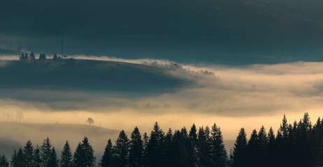 Beautiful autumn scenic panorama of foggy Carpathian mountains in the early morning. Fog,...