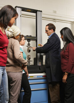 Engineering Teacher and Students with Tensile Machine