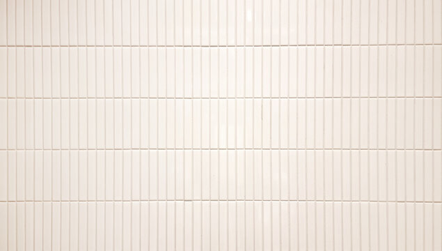close up image of white beige ceramic clay wall tiles use as background with blank space for design. interior wall finishing material. metro tiles background. subway brick in vertical pattern.