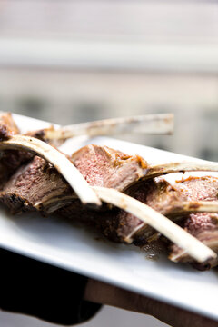 Close-up of lamb chops with bones on a platter, at an event, Canada