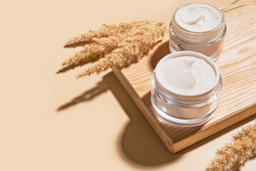 Face cream jars with natural dry grass