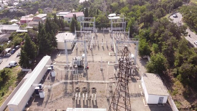 Power substation for a residential zone. Natural environment with aerial view in 4k. Tbilisi, Georgia. 