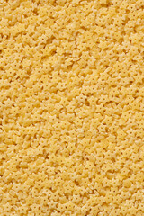 Pasta stelline texture. Dry uncooked italian pasta stelline natural texture or background, close-up, high resolution.