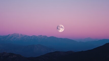 Moon rising over a mountain range, with the twilight sky gradually darkening in the background.