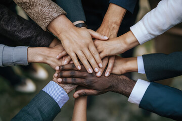 A Powerful Moment of Unity: Diverse Hands Coming Together in Solidarity for a Common Goal and Shared Triumph