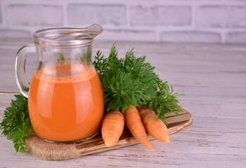 Carrot juice in a transparent jug. Close-up. Vegetable juice.