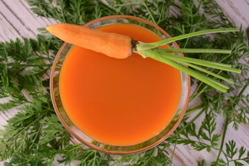 Carrot juice in a glass of flat lei. Vegetable juice.
