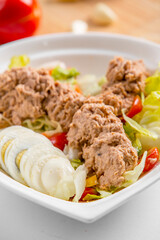 tuna salad with boiled eggs and vegetables on a plate restaurant menu