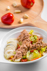 tuna salad with boiled eggs and vegetables on a plate restaurant menu