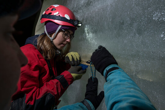 Researchers take samples from an ice cave in European Alps of Austria