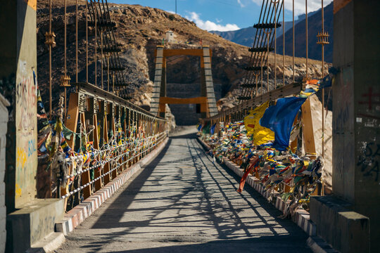 Chicham Bridge with prayer flags over Spiti Valley in Northern India; Himachal Pradesh, India