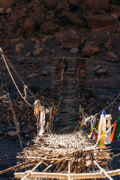 Bridge with Buddhist prayer flags crossing a river at Phuktal Gompa (Monastary), near Purne, Zanskar, Ladakh, India; Zanskar, Ladakh, India