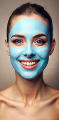 Cosmetic mask made of blue clay on the face of a young beautiful woman.