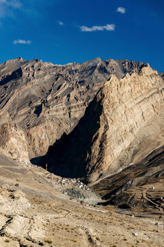 Rugged mountainous landscape and village with a road between Zangla and Wanla, Zanskar, Ladakh; Zanskar, Ladakh, India