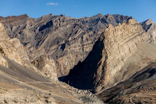 Rugged mountainous landscape and village with a road between Zangla and Wanla, Zanskar, Ladakh; Zanskar, Ladakh, India