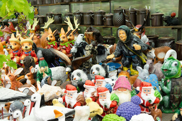 Colorful ceramic figurines of fairy tale characters for decorative purposes at the market.
