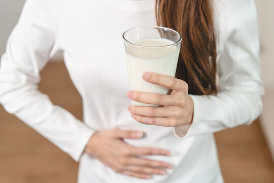 lactose intolerance concept. Woman having a stomach ache from lactose intolerance.