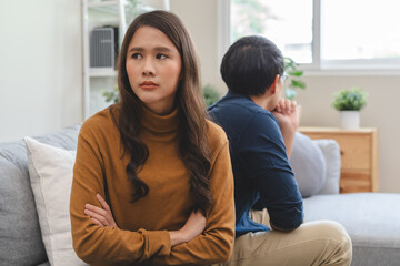 Family problem concept, Close-up hands of Asian wife sitting on sofa and husband sitting back to...