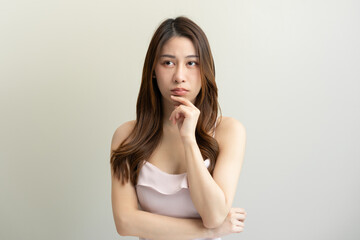 Fototapeta premium asian woman in color casual dress thinking and imagination isolated on pink background