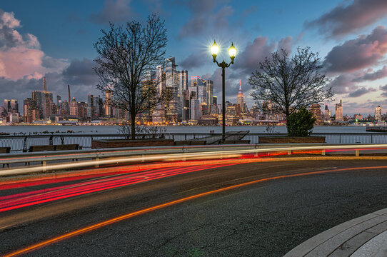 Midtown Manhattan skyline and light trails on the street at the Weehawken shipyard, New Jersey, USA; Weehawken, New Jersey, United States of America