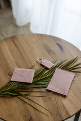Big pink wallet on a wooden table