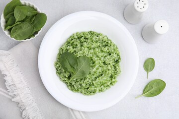 Delicious spinach risotto on light grey table