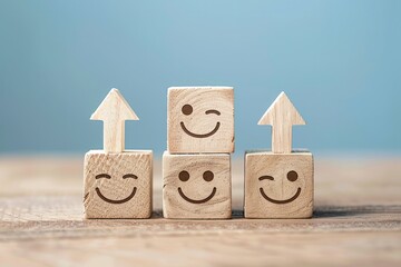 Three wooden blocks with smiling faces on them