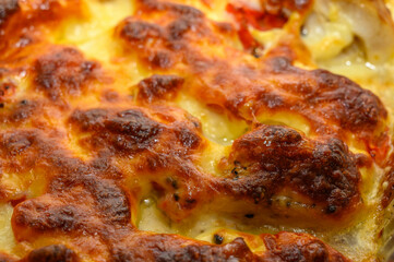 Baked potatoes in the peel stuffed with cheese with garlic and herbs.