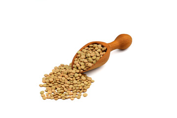 Green lentils in wooden bowl on isolated white background. Top view, copy space. Flat lay.