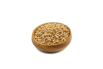 Green lentils in wooden bowl on isolated white background. Top view, copy space. Flat lay.