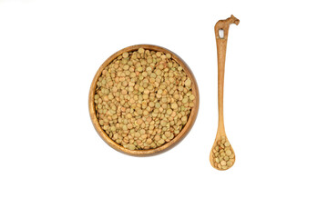 Green lentils in wooden bowl on isolated white background. Top view, copy space. Flat lay.