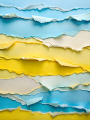 Fototapeta premium Torn Paper Tapestry: A vibrant collage of blue, yellow, and white torn paper strips, forming a textured abstract background with copy space. 