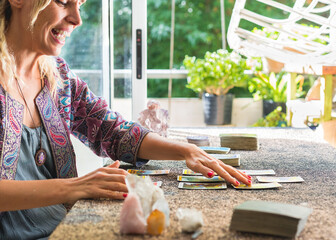Side view of a tarot reader reading the cards