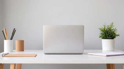 Fototapeta premium Minimalist office setup with a laptop, a notepad, and a cozy atmosphere, ideal for productive and relaxed writing sessions