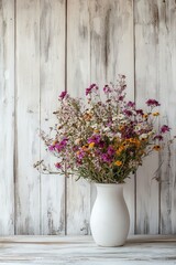 Beautiful wildflowers in a rustic vase on a wooden table