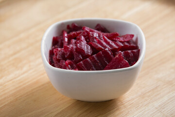 tahini sauce in a small bowl served on a wooden table spiced with paprika powder on it