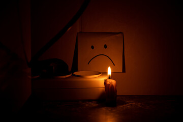 On the kitchen table in the dark near the socket there is a candle, and next to it lies a piece of...