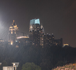 Skyline Cityscape showing office buildings,  condos, and hotels at night during a rain storm.