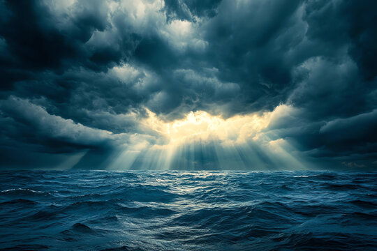 Sun rays breaking through dark storm clouds over the ocean, dramatic weather, hope after the storm