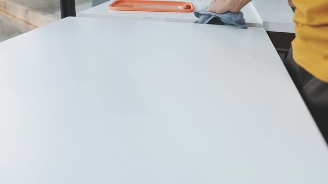 Cleanliness asian young woman working chore cleaning on table at home, hand wearing glove using rag rub remove dust with spray bottle. Household hygiene clean up, cleaner, equipment tool for cleaning